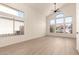 Spacious living room with a vaulted ceiling, modern flooring, and ample natural light at 8928 E Crescent Ave, Mesa, AZ 85208