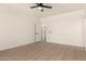 Spacious main bedroom featuring modern flooring, ample natural light, and a ceiling fan at 8928 E Crescent Ave, Mesa, AZ 85208