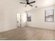 Spacious main bedroom with ample natural light, a ceiling fan, and modern flooring at 8928 E Crescent Ave, Mesa, AZ 85208