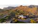 Aerial view showcases a beautiful community with a golf course, clubhouse, and desert landscaping at 9548 E Kiva Ln, Gold Canyon, AZ 85118