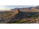 Scenic aerial view of a desert community with a golf course nestled among mountains at sunset at 9548 E Kiva Ln, Gold Canyon, AZ 85118