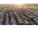 Sunrise aerial view over desert mountain community with golf course and community pool at 9548 E Kiva Ln, Gold Canyon, AZ 85118