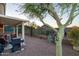 Backyard area with barbecue, seating, beautiful landscaping, and views of neighboring houses at 9548 E Kiva Ln, Gold Canyon, AZ 85118