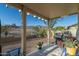 Covered patio offers stunning mountain views, comfortable seating, and outdoor cooking space at 9548 E Kiva Ln, Gold Canyon, AZ 85118
