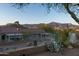 A desert landscaped backyard features a block wall fence and a great mountain view at 9548 E Kiva Ln, Gold Canyon, AZ 85118