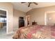 Cozy bedroom features plush patterned bedding, a ceiling fan, and a walk-in closet at 9548 E Kiva Ln, Gold Canyon, AZ 85118