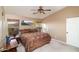Bright bedroom boasts mountain views, soft carpet, and a decorative ceiling fan at 9548 E Kiva Ln, Gold Canyon, AZ 85118
