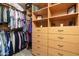 Spacious walk-in closet featuring custom wooden shelving and ample storage space at 9548 E Kiva Ln, Gold Canyon, AZ 85118
