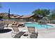 Community pool with lounge chairs and desert scenery for relaxation at 9548 E Kiva Ln, Gold Canyon, AZ 85118