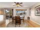 Dining area with wood floors, ceiling fan, and a sliding glass door that leads to the patio at 9548 E Kiva Ln, Gold Canyon, AZ 85118