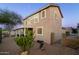 Back exterior of home with a covered patio, desert landscaping, and lush greenery offering a private outdoor retreat at 9548 E Kiva Ln, Gold Canyon, AZ 85118