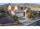 Southwest style home with a tile roof, two car garage, and desert landscaping with a mountain view in Scottsdale, Arizona at 9548 E Kiva Ln, Gold Canyon, AZ 85118