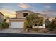 Exterior view of a stucco house with a tile roof, two car garage, and desert landscaping in Scottsdale, Arizona at 9548 E Kiva Ln, Gold Canyon, AZ 85118
