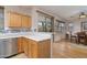 Open kitchen featuring white countertops, wooden cabinetry, and modern stainless steel appliances at 9548 E Kiva Ln, Gold Canyon, AZ 85118