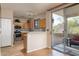 Well-equipped kitchen with stainless steel appliances and wooden cabinets, adjacent to an outdoor patio at 9548 E Kiva Ln, Gold Canyon, AZ 85118