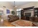 Open floor plan living room with wood floors, large television, entertainment center, and leather sofa at 9548 E Kiva Ln, Gold Canyon, AZ 85118