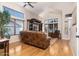 Bright living room boasts wood floors, vaulted ceilings, large windows, and stylish furnishings at 9548 E Kiva Ln, Gold Canyon, AZ 85118