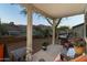 Charming covered patio with comfortable seating, perfect for enjoying the serene desert surroundings and outdoor dining at 9548 E Kiva Ln, Gold Canyon, AZ 85118