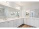 Bright bathroom featuring double vanity with white countertops and dark wood-look tile flooring at 10158 W Angels Ln, Peoria, AZ 85383