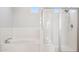 Close-up of the glass-enclosed walk-in shower and a soaking tub with tile surround at 10158 W Angels Ln, Peoria, AZ 85383