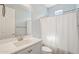 Neutral bathroom featuring a modern vanity, large mirror, and shower with decorative curtain at 10158 W Angels Ln, Peoria, AZ 85383