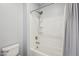 Bathroom shower and tub with brushed metal shower head and white tile surround at 10158 W Angels Ln, Peoria, AZ 85383