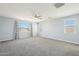 Light blue primary bedroom with ceiling fan, lots of light and neutral carpet at 10158 W Angels Ln, Peoria, AZ 85383