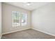 Bright bedroom with plush carpeting and abundant natural light from two windows at 10158 W Angels Ln, Peoria, AZ 85383