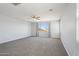 Large primary bedroom featuring neutral carpet, ceiling fan, and great natural light at 10158 W Angels Ln, Peoria, AZ 85383