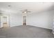 Bright primary bedroom featuring neutral carpet and fan with ample space at 10158 W Angels Ln, Peoria, AZ 85383