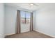This light blue bedroom has a neutral carpet and a window with curtains at 10158 W Angels Ln, Peoria, AZ 85383