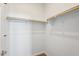 Walk-in closet features built-in shelving and wood rods for ample storage at 10158 W Angels Ln, Peoria, AZ 85383