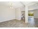 Open dining room with wood-look tile flooring and modern chandelier at 10158 W Angels Ln, Peoria, AZ 85383