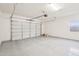 A view of the garage with epoxy floors and closed garage door at 10158 W Angels Ln, Peoria, AZ 85383