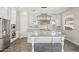 Bright, open kitchen with island seating, stainless appliances, and stylish pendant lighting at 10158 W Angels Ln, Peoria, AZ 85383