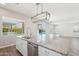 Kitchen with granite island, stainless steel dishwasher, and view to pool at 10158 W Angels Ln, Peoria, AZ 85383