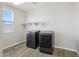 Laundry room featuring modern washer and dryer with overhead shelving at 10158 W Angels Ln, Peoria, AZ 85383