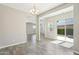 Bright living area featuring wood-look tile, slider to backyard, and backyard view at 10158 W Angels Ln, Peoria, AZ 85383