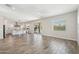 Spacious living area with wood-look tile, ceiling fan, and open floor plan at 10158 W Angels Ln, Peoria, AZ 85383
