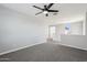 Spacious loft area featuring a ceiling fan, neutral paint, and plush carpeting at 10158 W Angels Ln, Peoria, AZ 85383