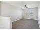 Upstairs loft area featuring neutral walls, plush carpet, and a window with natural light at 10158 W Angels Ln, Peoria, AZ 85383