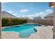 Beautiful backyard with a sparkling in-ground pool, stone patio, and privacy landscaping at 10158 W Angels Ln, Peoria, AZ 85383