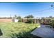 Expansive backyard featuring a well-maintained lawn, block fence, lush greenery, and a convenient storage shed at 1027 E El Camino Dr, Phoenix, AZ 85020