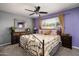 Charming bedroom with a decorative wrought iron bed frame, plush bedding, and a large window with natural light at 1027 E El Camino Dr, Phoenix, AZ 85020
