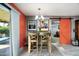 Cozy dining area with a rustic wooden table, stylish lighting, and colorful artwork at 1027 E El Camino Dr, Phoenix, AZ 85020