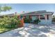 Quaint single-story home featuring colorful accents and a well-kept front yard at 1027 E El Camino Dr, Phoenix, AZ 85020