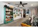 Spacious living room with a futon, art decorations on the wall, and a bookshelf at 1027 E El Camino Dr, Phoenix, AZ 85020
