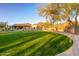 A lush green lawn complements this elegant home with mountain views in the background at 10329 E Star Of The Desert Dr, Scottsdale, AZ 85255