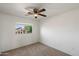 Clean, minimalist bedroom with natural light and neutral carpet, ideal for relaxation at 10329 E Star Of The Desert Dr, Scottsdale, AZ 85255