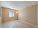This naturally lit bedroom features neutral walls and carpet and a bright window at 10329 E Star Of The Desert Dr, Scottsdale, AZ 85255